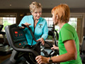 Part-time jobs for seniors who travel to warm climates in the winter- a woman helps train seniors at a fitness center in Naples, Florida