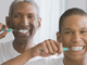 African American grandfather, father and son brushing teeth