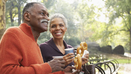 Couple with Coffee and Pretzels in City Park, New York City, New York, USA
