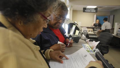 some states require photo i.d. before you can vote- two senior citizens register for a driver's license with a photo in tennessee