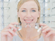 Woman trying on glasses in optometrists shop