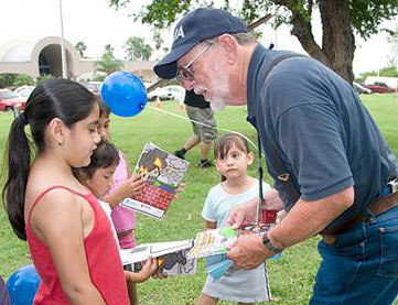 A man hands out emergency preparedness coloring books