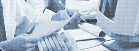 Photo of man reading document at desk