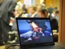 A view of the press conference audience behind a computer image of the fire on the Deepwater Horizon oil platform.