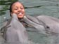 girl in water with dolphins