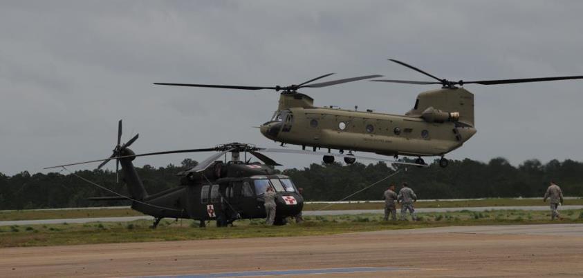 Photo: August 30 photo from NORAD and USNORTHERN Command -  Soldiers from the 7th Battalion, 101st Aviation Regiment, 159th Combat Aviation Brigade, 101st Airborne Division land at Cairns Army Airfield, Fort Rucker, Ala., as a staging area awaiting the call to assist relief efforts resulting from Hurricane Isaac. The Soldiers and a  combination of HH-60 Alpha Plus Black Hawk and CH-47F Chinook helicopters stand ready to support our federal and State partners. (U.S. Army photo by Kelly Pate)
