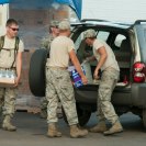 Photo: New Orleans, LA, September 1,2012 - Members of the LA National Guard give  ice, MREs (meals ready to eat) and tarps sit in a distribution center in New Orleans.  Residents affected by Hurricane Issac lined up in their cars to get these supplies.  FEMA is working with local, state and other federal agencies and the military to provide assistance to residents affected by Hurricane Issac.