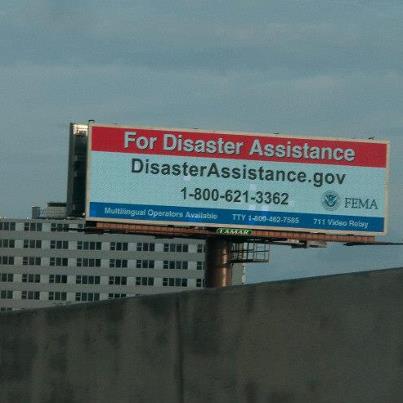 Photo: New Orleans, La., Sep. 4, 2012 -- A billboard near the I-10 Freeway in New Orleans, La., lists the contract information for FEMA registration. FEMA is working with the private sector to insure that Hurricane Isaac survivors are able to receive this registration information.