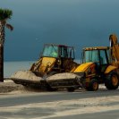 Photo: Gulfport, Miss., Sep. 5, 2012 -- Endloaders clear sand off of Highway 90 and beach parking areas pushed up by wind and storm surge from Hurricane Isaac. FEMA is providing Public Assistance to several counties in Mississippi which will help cover costs for beach and highway cleanup.