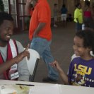 Photo: LaPlace, La., Sep. 5, 2012 -- Jamaal Johnson, an AmeriCorp volunteer teaches a child sign language at the St. John's Baptist Community Center where a temporary shelter has been set up for Hurricane Isaac survivors. FEMA is working with local, state and federal agencies to provide services for residents affected by Hurricane Isaac.