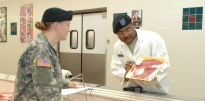 Nutritionist visiting meat counter at commissary