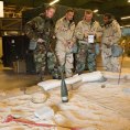 Photo: Service members use an Airman’s Manual to identify simulated unexploded ordnance during a Chemical Biological Radiological and Nuclear (CBRN) survival skills class Aug. 9, 2012, at Dover Air Force Base, Del. Identifying, marking and reporting are some of the responsibilities Airmen have to perform if assigned to a Post Attack Reconnaissance team. (U.S. Air Force photo by Roland Balik)