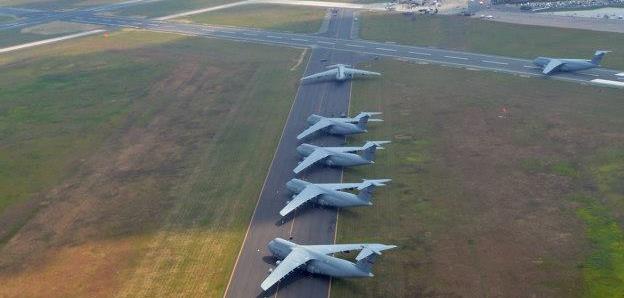Photo: U.S. Air Force C-5 Galaxies cargo aircraft aligned on a Westover, Mass. Air Reserve Base runway, to make room for air show aircraft this past August. The 2012 Great New England Air Show was the largest Westover has had since 1974, boasting more than 60 aircraft. (U.S. Air Force photo by SrA. Kelly Galloway)