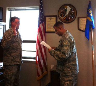 Photo: Master Sgt. Scott Nybakken, left, of the 166th Aircraft Maintenance Squadron, Delaware Air National Guard, recites the oath of enlistment as he reenlists on August 24, 2012. Capt. Jaime Ramirez, right, an officer in the 166th AMXS, swears in Sgt. Nybakken in the captain's office within the main hangar at the New Castle ANG Base. (U.S. Air Force photo/Tech. Sgt. Veronica Mora) (bjm)
