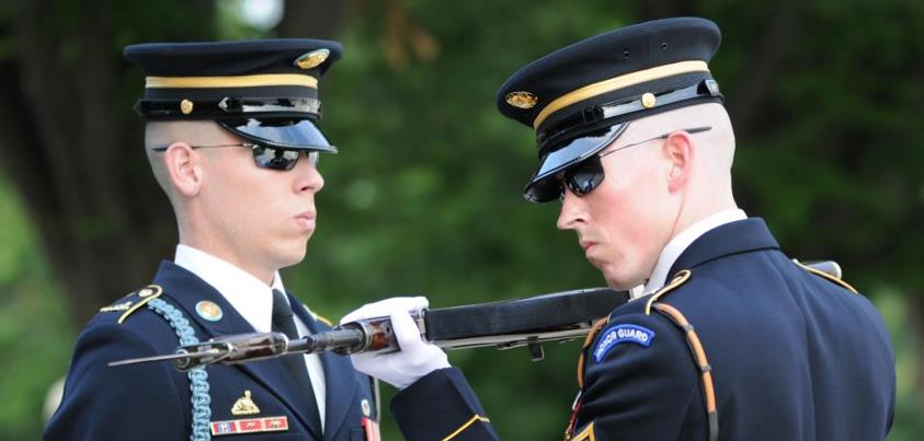 Photo: Sgt. Erik McGuire (right), Tomb Sentinel, Tomb of the Unknown Soldier, 3d U.S. Infantry Regiment (The Old Guard), inspects the weapon of a Tomb Guard during a guard change, Aug. 30, at the Tomb of the Unknown Soldier in Arlington National Cemetery. Prior to this guard change, McGuire was awarded The Guard, Tomb of the Unknown Soldier Identification Badge. Tomb Guards must pass a series of tests and training before they earn the right to be called a Tomb Sentinel. U.S. Army photo by Megan Garcia