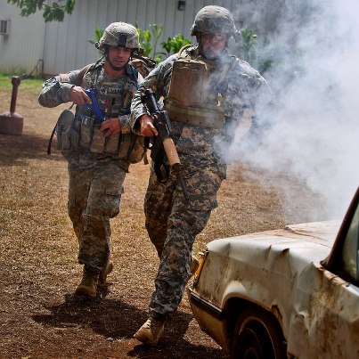 Photo: U.S. Army Staff Sgt. Tony Gonzalez and Staff Sgt. Joseph Lollino, combat medics assigned to Tripler Army Medical Center, respond to a simulated vehicle attack during a combat trauma evaluation as part of the 2012 Pacific Regional Medical Command Best Medic Competition Aug. 28, at Schofield Barracks, Hawaii. Photo by U.S. Air Force Tech. Sgt. Michael R. Holzworth/Released