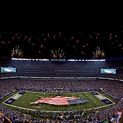 Photo: Service members representing the Marines, U.S. Navy U.S. Coast Guard, United States Air Force and U.S. Army display a U.S.-shaped American flag across the field during  pre-game ceremonies for the NFL's season opening game between the New York Giants and Dallas Cowboys at MetLife Stadium Sept. 5. More than 60 Troops presented the large flag as Queen Latifah sang the national anthem. (US Army Photo by John Manley)