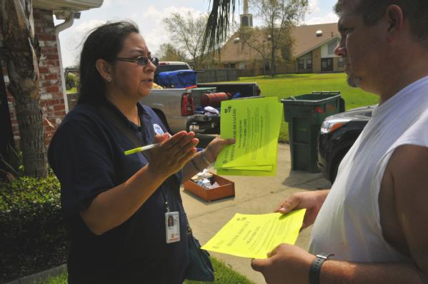 La Place, La., Sep. 3, 2012 -- Community Relations Specialist, Patricia "Alley" West, (left) goes door to door in neighborhoods affected by Hurricane Isaac handing out flyers and providing information to assist residents who may qualify for FEMA assistance. Areas in La Place flooded when the slow moving storm passed through.