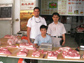 Photo of David Ortega and Laping Wu with a pork seller in Shijiazhuang, Hebei Province, China.