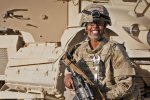 Staff Sgt. Muna Nur, a native of Somalia and a medic 10th Sustainment Brigade, Task Force Muleskinner, laughs with some National Guard Soldiers before embarking with them on a convoy from Forward Operating Base Ghazni to Bagram Airfield, on Afghanistans notorious Highway 1.