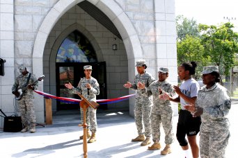 During a Sept. 7 ribbon-cutting celebrating the reopening of the West Casey Chapel, members of a Gospel choir sing for an audience of about 60 Soldiers, civilians and families members. Besides an all-new look, the chapel now has more space, a full-size kitchen, and an outdoor playground and parking lot, among other improvements.