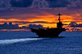 The aircraft carrier USS George Washington sails through calm seas near Guam at sunset while under way in the Pacific Ocean, Sept. 8, 2012. The George Washington is the centerpiece of Carrier Strike Group 5, the US Navy’s only continuously forward deployed carrier strike group, based out of Yokosuka, Japan. Carrier Strike Group 5 is currently on a routine Western Pacific patrol. U.S. Navy photo by Petty Officer 3rd Class Paul Kelly