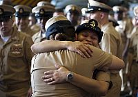 Senior Chief Hospital Corpsman Cheri Snaza hugs newly-pinned Chief Logistics Specialist Heidi Molinabautista following the final chief pinning ceremony to be held aboard the aircraft carrier USS Enterprise (CVN 65). 