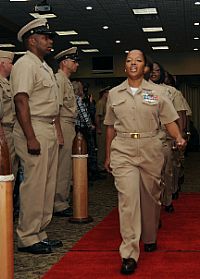 Thirty-two chief petty officer selects march in formation during a chief petty officer pinning ceremony for Sailors stationed aboard the aircraft carrier USS George H.W. Bush (CVN 77).