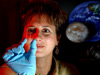 Dr. Lisa Monaco, project scientist for the Lab-on-a-Chip Applications Development program, examines a prototype chip.