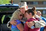 Lance Cpl. Philip Villaire, rifleman, Company G, 2nd Battalion, 7th Marine Regiment, hugs his mother, Gigi Madamba (left), and his girlfriend, Danielle Boushey, before he boarded a bus and deployed to Afghanistan Sept. 12, 2012. 