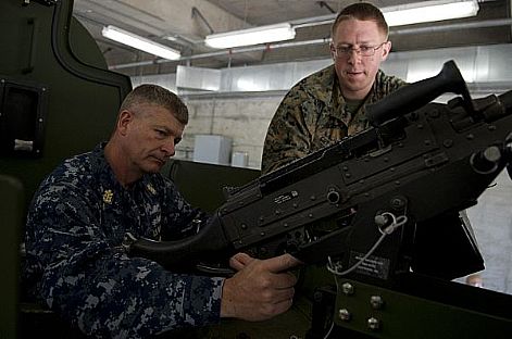 Lance Cpl. Justin Gresham shows Master Chief Petty Officer of the Navy (MCPON) Rick D. West the gun turret of the Marine Corps uparmored vehicle Bearcat during a visit to Bangor, Wash.  U.S. Navy photo by Mass Communication Specialist 2nd Class Thomas L. Rosprim (Released)  120726-N-IV546-068