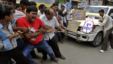 Indian people pull a car by rope and shout slogans during a protest against the price hike in diesel and capping the number of subsidized cooking gas cylinders in Ahmadabad, India, September 14, 2012.