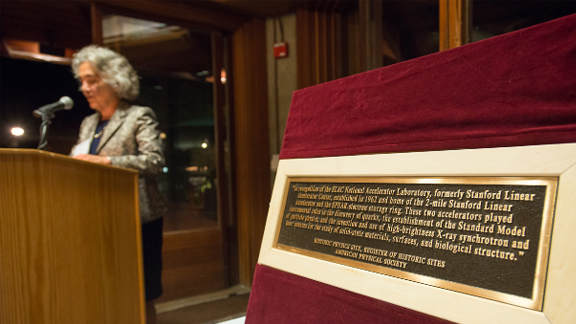 SLAC Director Persis Drell speaks during a special dinner at the Stanford Faculty Club on Friday. Also during the dinner, Barry C. Barish, past president of the American Physical Society and an emeritus physics professor at the California Institute of Technology, presented a plaque, pictured at right, on behalf of APS recognizing SLAC as a historic site for its many groundbreaking discoveries in science. (Photo by Matt Beardsley)