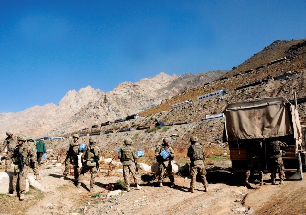 Soldiers assigned to 10th Sustainment Brigade work together to load a truck with supplies delivered near the Salang tunnel, Afghanistan. The supplies were delivered by a low-cost, low-altitude parachute drop -- the first ever near the tunnel.