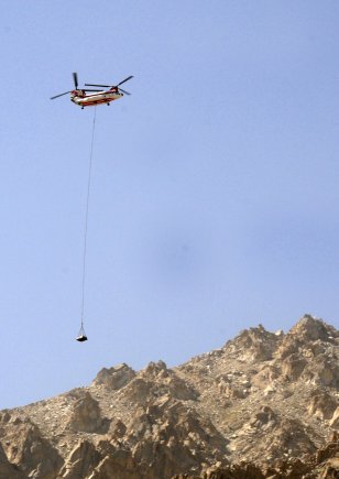 A CH-46 helicopter delivers supplies using long line position placement near the Salang tunnel, Afghanistan. The mission was the first conducted near the Salang tunnel to support Soldiers serving in support of Operation Enduring Freedom.