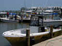 A photo of a few citizens and boats enlisted in helping with the oil spill clean as they prepare to launch.