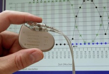 A German pacemaker that sends text warning message to a doctor when a patient's heart is in critical condition is shown against the backdrop of a cardiological graph at the St. Josefs hospital in the eastern city of Potsdam February 26, 2004. REUTERS/Arnd Wiegmann