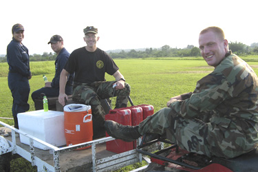 CDR John Moroney assists with moving supplies.