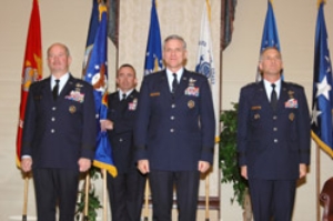 Maj. Gen. James A. Hawkins, far right, assumed command of 18th Air Force from Lt. Gen. William Welse...