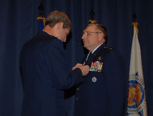 (l to r) USTRANSCOM Commander, Gen. Norton A. Schwartz, presents Maj. Gen. James P. Czekanski with t...