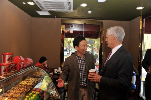 Secretary Bryson enjoys a cup of coffee at a Mrs. Fields Cookies and talks with other customers