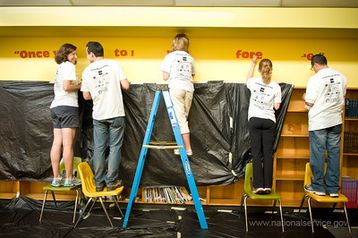 Volunteers create a wall mural in the library of West Education Campus, a K - 8 public school in Washington, DC. The volunteers were at the school as part of a September 11th National Day of Service and Remembrance event organized by HandsOn Greater DC Cares and U.S. Vets -- United States Veterans Initiative. The event was attended by over 200 White House and Corporation for National and Community Staff and their families. (Corporation photo by Sam Kittner, 2011)