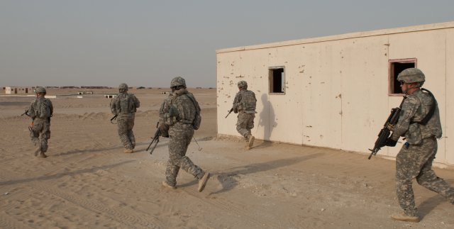 Soldiers of A Company, 4th Battalion, 118th Infantry Regiment jog to their next objective during a platoon live-fire exercise at the Udairi Range Complex in northern Kuwait, July 31, 2012. The Soldiers cleared buildings and a trench complex during the exercise. In addition to undertaking camp and security-force operations, the South Carolina Army National Guard Soldiers have kept up the pace of their training since deploying to Kuwait in April.