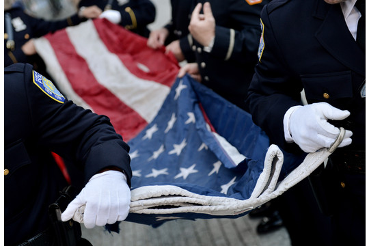 Police Officers of the Port Authority of New York and New Jersey carry an American flag.