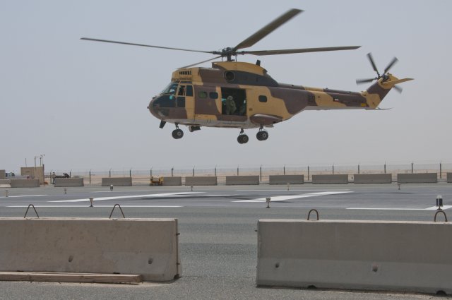 A Kuwaiti military helicopter prepares to land at the troop medical clinic at Camp Arifjan, Kuwait, as part of a medical evacuation exercise, April 26, 2012. Aboard the aircraft, U.S. and Kuwaiti service members care for a simulated casualty injured by a simulated active shooter. Third Army is dedicated to shaping the future by holding joint exercises with partner nations.