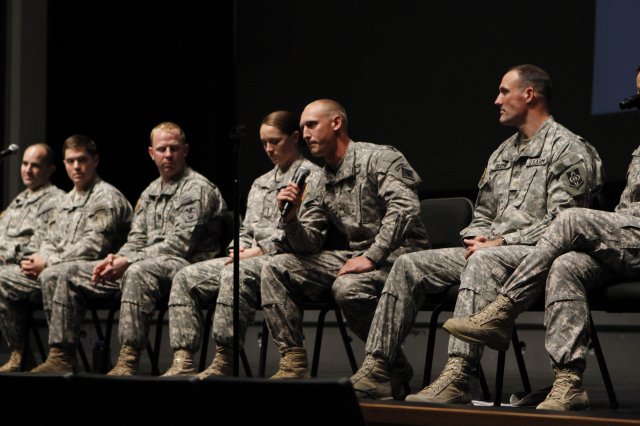 Three U.S. Military Academy graduates joined forces during a branch panel discussion to represent the Engineer Corps. Capt. John Chambers, a 2006 graduate, serves as the chief of training for the Sapper Leader Course. He spoke to cadets alongside 1st Lt. Rachel Neasham, Class of 2009, and 2nd Lt. Michael Eckland, Class of 2011, (pictured with microphone) who is serving as a platoon leader in 57th Sapper Company at Fort Bragg, N.C. Maj. Anna Maria Slemp, a Class of 1995 graduate, joined her husband Maj. Timothy Slemp from Fort Leonard Wood, Mo., to represent the Military Police.