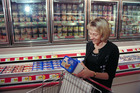 A woman reading a food label - Click to enlarge in new window.
