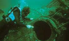 A diver examines the wreck of U-85.