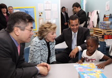 Locke, Boxer and Villaraigosa at table with young child.