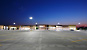 Photo of the Walmart Supercenter from across the parking lot at night. The photo shows the uniform lighting of the entire site.